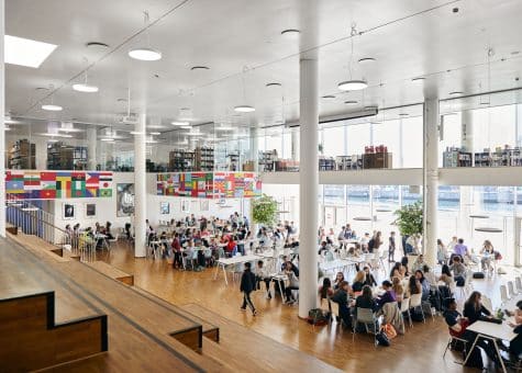photo of students in the cafeteria with the library above them