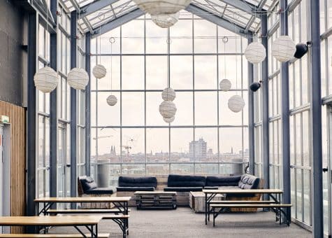photo of glassed in area at CIS campus with desks for sitting