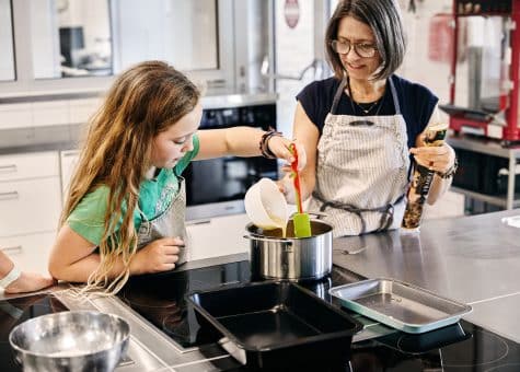 photo of teacher and student cooking