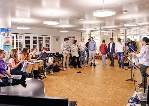 photo of students playing music and being conducted