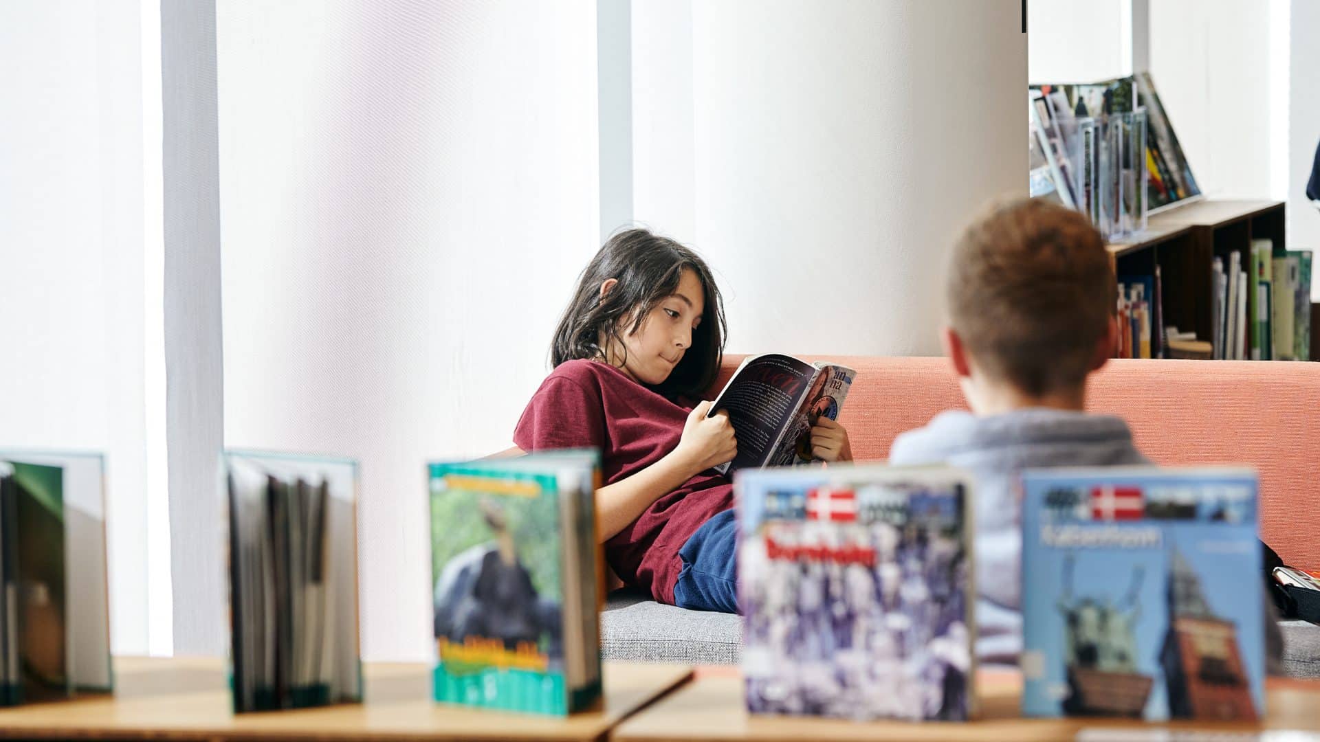 photo of students in the library reading books