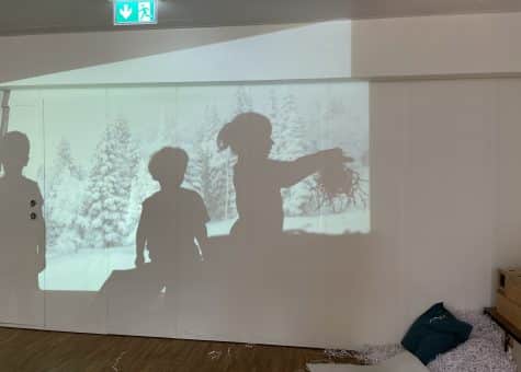 photo of early childhood students interacting with a projection
