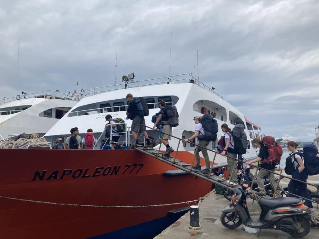 students boarding boat in sulawesi