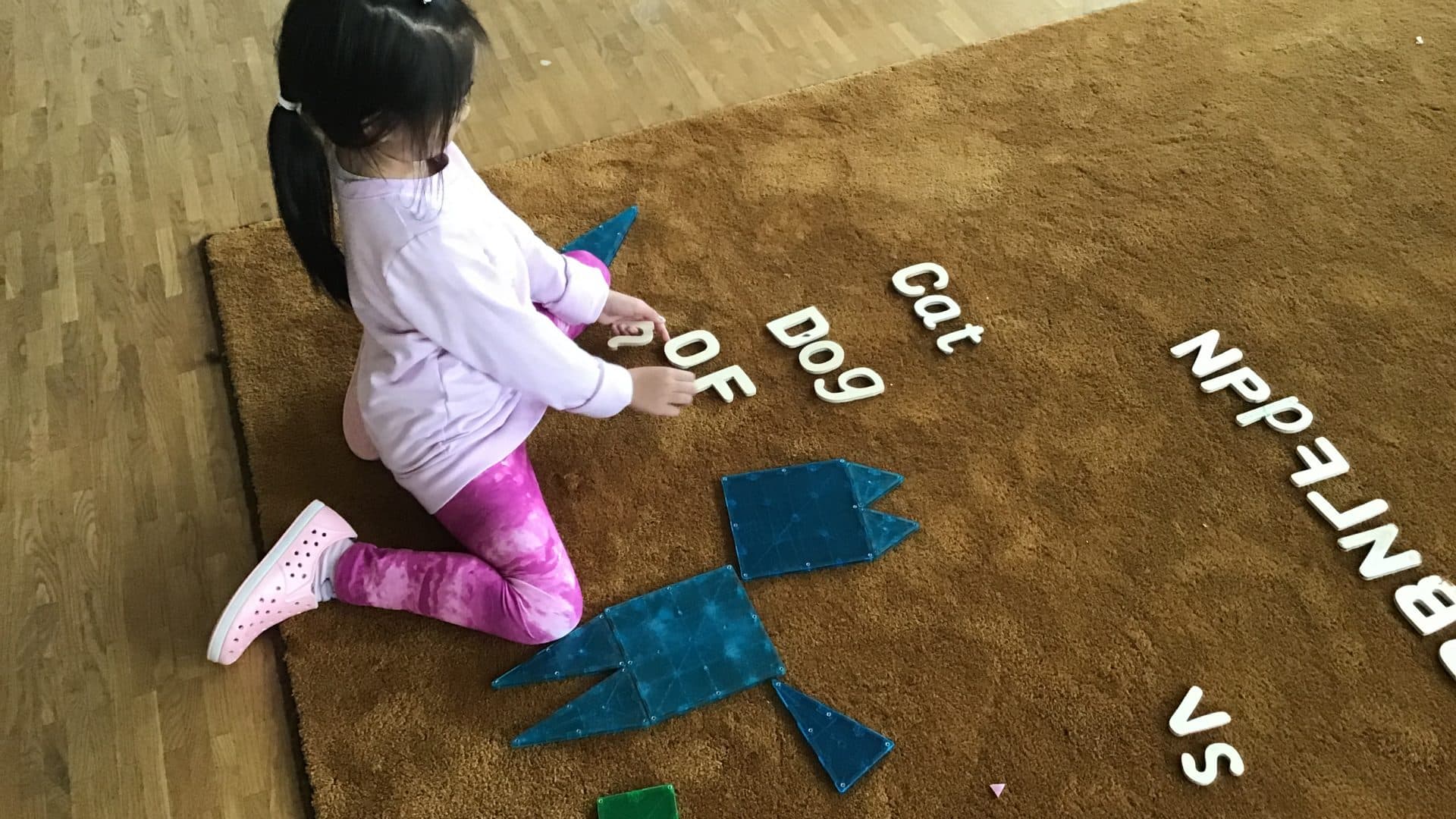 Kindergarten student learning letters